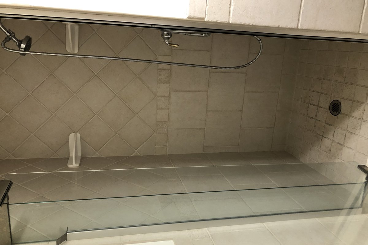 Before remodel: Outdated acrylic bathtub and shower stall with curtain in El Cajon.